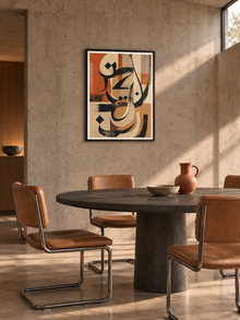 Terracotta Script: terracotta and charcoal abstract Arabic calligraphy, displayed in a slim black frame in a styled interior.