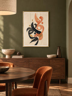 Coral Verse: coral and charcoal Arabic abstract calligraphy, displayed in a slim gold frame in a styled interior.