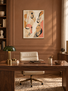 Sand Gesture: loose Arabic-inspired marks over sand and peach abstract shapes, displayed in a slim gold frame in a styled interior.
