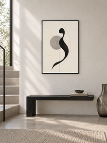 Quiet Mark: minimal black calligraphic form with a grey circle, displayed in a slim black frame in a styled interior.