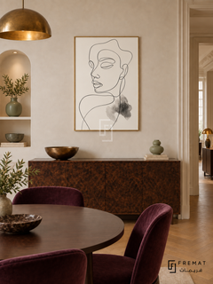Contour by FREMAT: portrait line art in a gold PVC frame with a printed white border, displayed in a styled interior.