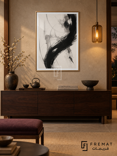 Ink Motion by FREMAT: expressive brushwork in a gold PVC frame with a printed white border, displayed in a styled interior.