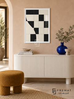 Checker Rhythm by FREMAT: an abstract checker pattern in a white PVC frame with a printed white border, displayed in a styled interior.
