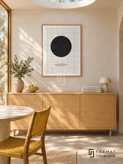 Sun Grid by FREMAT: a black sun and fine grid in a wooden texture PVC frame with a printed white border, displayed in a styled interior.