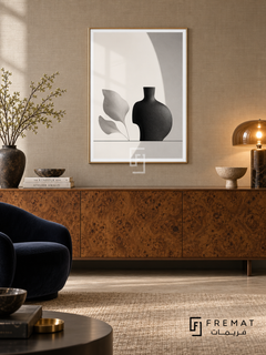 Quiet Vessel by FREMAT: a sculptural vase and leaves in a gold PVC frame with a printed white border, displayed in a styled interior.