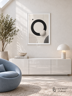 Orbit by FREMAT: orbital circles and a sphere in a white PVC frame with a printed white border, displayed in a styled interior.