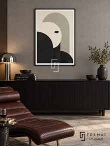 Monochrome Portrait by FREMAT: an abstract monochrome face in a black PVC frame with a printed white border, displayed in a styled interior.