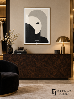 Monochrome Portrait by FREMAT: an abstract monochrome face in a gold PVC frame with a printed white border, displayed in a styled interior.