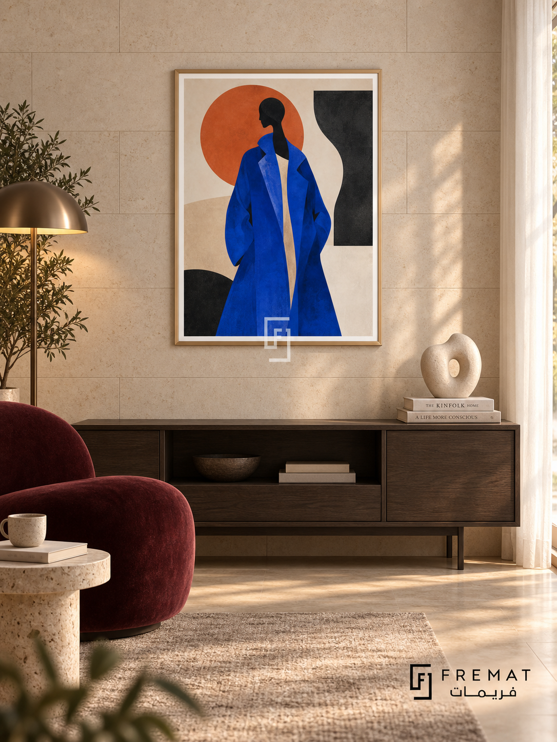 Fashion Block cobalt-blue fashion portrait in a slim champagne gold PVC frame with an even printed white border, above a walnut console beside a burgundy lounge chair and sunlit stone wall.