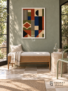 Woven Rhythm by FREMAT in a satin white PVC frame with a flat white printed border. Garden conservatory interior: muted eucalyptus stucco wall, 145cm cane bench with white linen seat, pale mint tubular chair right, stone cylinder side table, cream checker tile floor, leafy window shadows and blown-glass carafe.