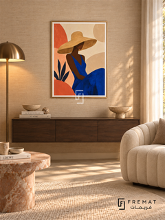 Sun Hat by FREMAT in a champagne gold PVC frame with a flat white printed border. Resort-inspired salon: natural flax grasscloth wall, 150cm dark walnut floating console, ivory channel-tufted chair right, pink marble pedestal table, warm cream rug, gauzy afternoon daylight and shaded brass floor lamp.