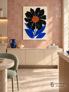 Graphic Flower by FREMAT in a satin white PVC frame with a flat white printed border. Light creative kitchen lounge: warm blush zellige tiled wall with subtle irregular glaze, 150cm white maple cabinet below art, mint upholstered chair left, cream terrazzo floor, diffuse afternoon light and simple cobalt pitcher.