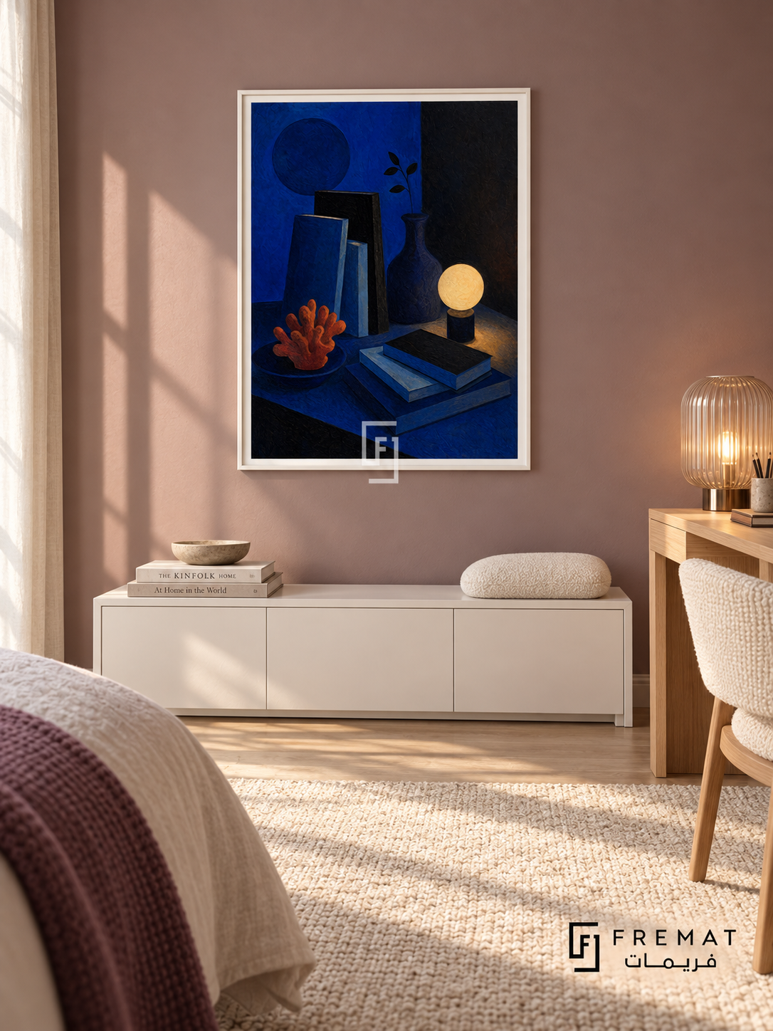 Night Table by FREMAT in a satin white PVC frame with a flat white printed border. Fresh quiet guest room: muted mauve matte wall, 145cm satin-white storage bench below artwork, light oak desk at far right and cream woven chair, cream carpet, soft early morning light and ribbed transparent lamp.