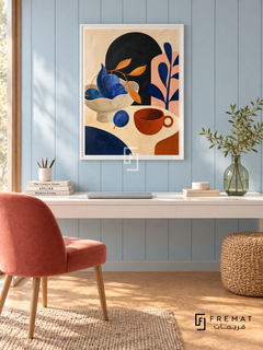 Playful Still Life by FREMAT in a satin white PVC frame with a flat white printed border. Fresh pastel creative studio: pale blue vertical timber wall, 150cm satin-white desk, coral upholstered chair at left, natural woven ottoman right, warm cork floor, luminous diffuse light and one clear green glass vase.