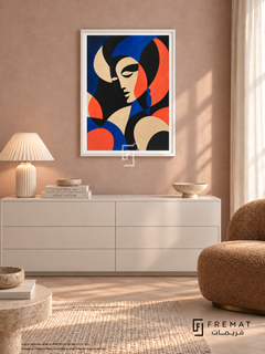 Statement Portrait by FREMAT in a satin white PVC frame with a flat white printed border. Quiet chic dressing lounge: pale dusty rose fabric wall, 150cm white lacquer chest, caramel boucle slipper chair right, ivory pleated lamp left, whitewashed parquet, gauzy morning light and stone dish.