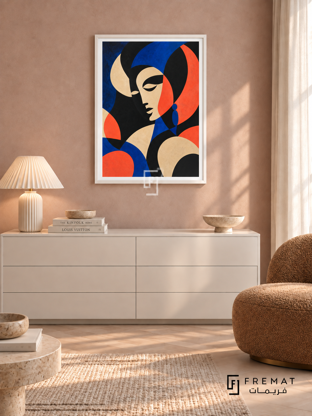 Statement Portrait by FREMAT in a satin white PVC frame with a flat white printed border. Quiet chic dressing lounge: pale dusty rose fabric wall, 150cm white lacquer chest, caramel boucle slipper chair right, ivory pleated lamp left, whitewashed parquet, gauzy morning light and stone dish.