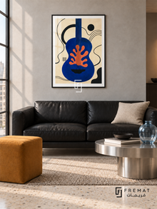 Blue Guitar by FREMAT in a matte black PVC frame with a flat white printed border. Contemporary music loft: pale grey microcement wall, 160cm black leather two-seat sofa, brushed steel low table right, ochre cube stool left, cream terrazzo floor, soft skylight and pale blue glass vessel.