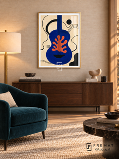 Blue Guitar by FREMAT in a champagne gold PVC frame with a flat white printed border. Refined listening salon: pale tan woven wallpaper, 155cm walnut console, deep teal velvet armchair left, dark marble cocktail table right, wool rug, warm shaded brass lamp with gentle sunset glow.