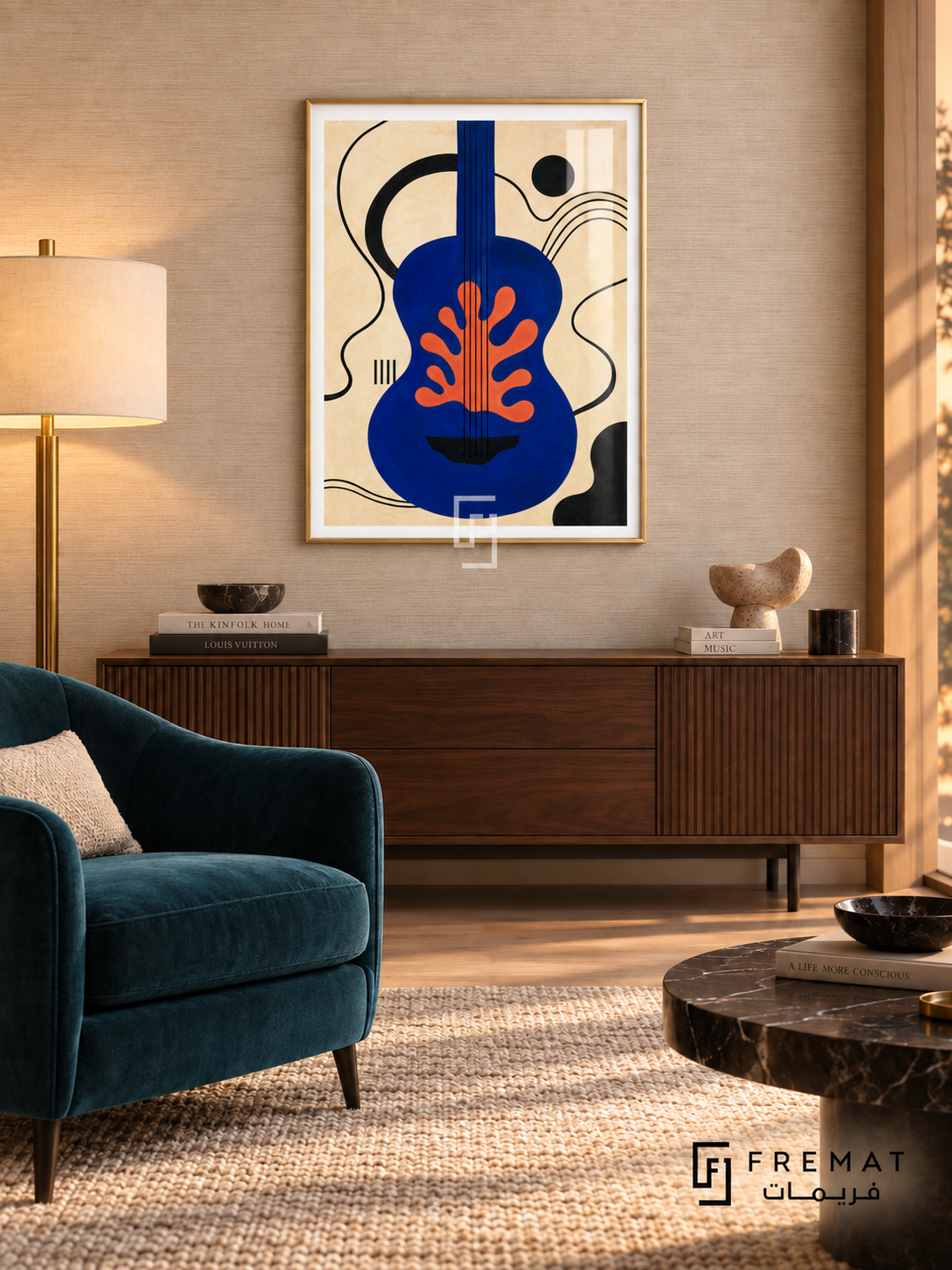 Blue Guitar by FREMAT in a champagne gold PVC frame with a flat white printed border. Refined listening salon: pale tan woven wallpaper, 155cm walnut console, deep teal velvet armchair left, dark marble cocktail table right, wool rug, warm shaded brass lamp with gentle sunset glow.