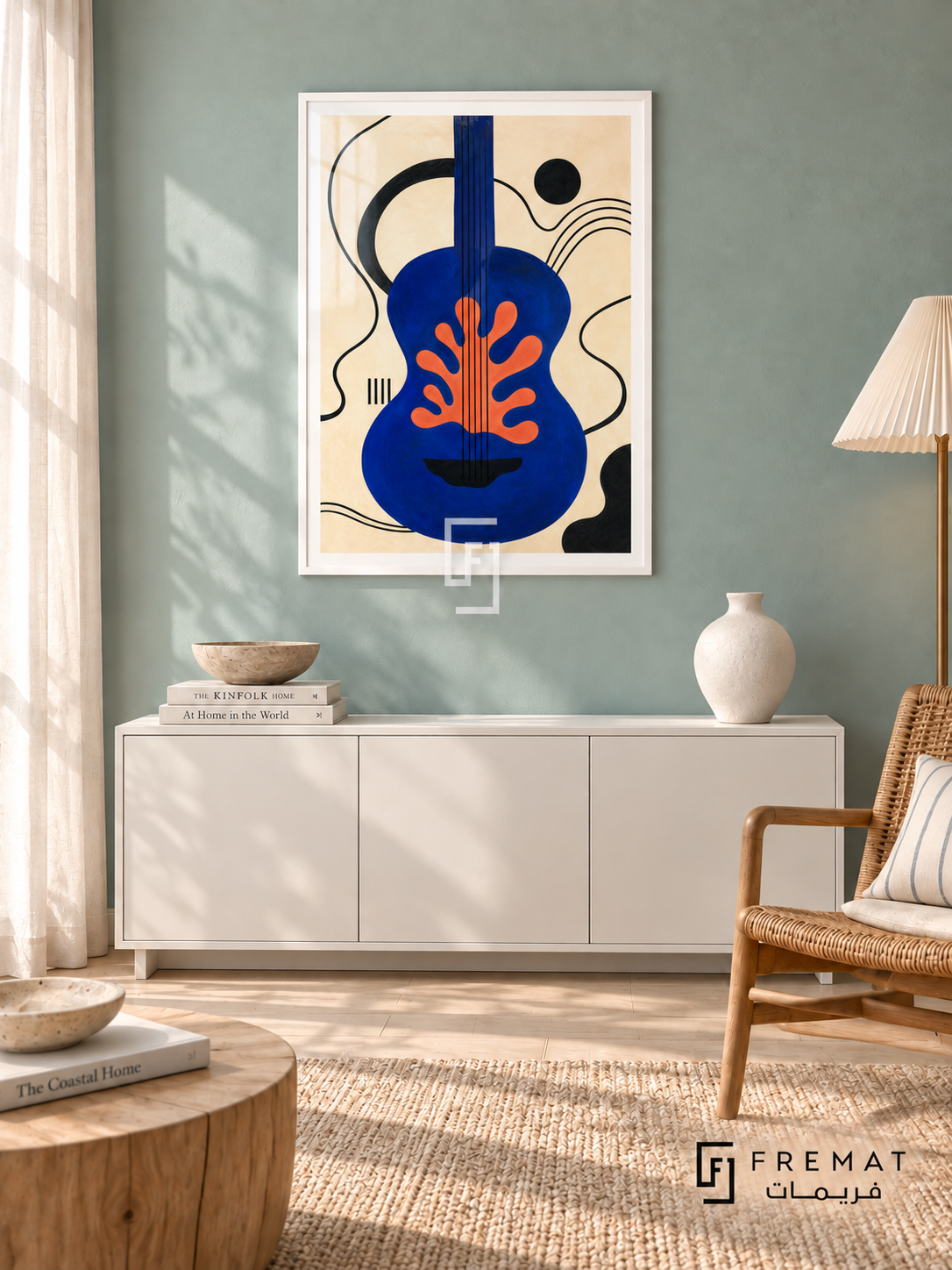 Blue Guitar by FREMAT in a satin white PVC frame with a flat white printed border. Coastal acoustic salon: muted seafoam chalk wall, 150cm satin-white cabinet, camel rattan chair right, pale oak drum table, whitewashed timber floor, late-morning curtain light and cream pleated shade.