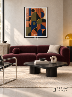 Colour Rhythm by FREMAT in a matte black PVC frame with a flat white printed border. Modern design lounge: pale neutral concrete wall, 160cm aubergine wool sofa, black powder-coated asymmetric coffee table, chrome chair left, cream flatweave rug, soft north light and sculptural yellow glass lamp.