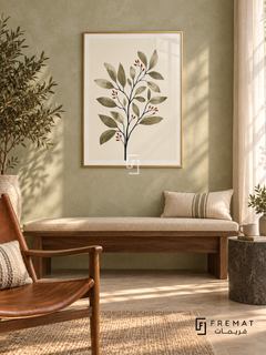 Botanical Stem NAT01 by FREMAT in a slim champagne gold PVC frame, with an even white printed border, subtle glazing reflections and furniture showing scale.