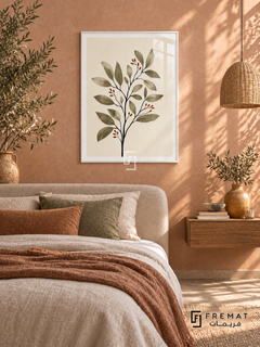 Botanical Stem NAT01 by FREMAT in a slim satin white PVC frame, with an even white printed border, subtle glazing reflections and furniture showing scale.