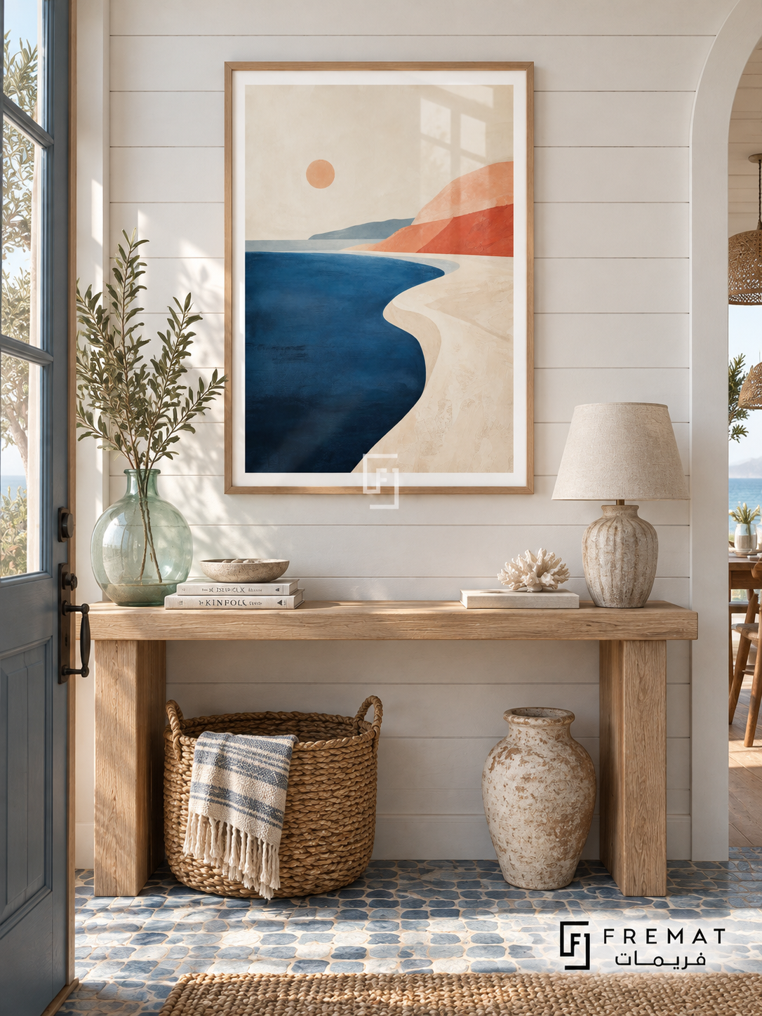 Coastal Calm NAT02 by FREMAT in a slim light wood-grain PVC frame, with an even white printed border, subtle glazing reflections and furniture showing scale.
