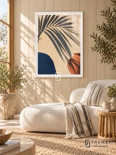 Palm Shadow NAT05 by FREMAT in a slim satin white PVC frame, with an even white printed border, subtle glazing reflections and furniture showing scale.