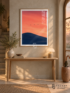 Birds at Dusk NAT07 by FREMAT in a slim light wood-grain PVC frame, with an even white printed border, subtle glazing reflections and furniture showing scale.