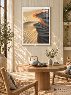 Sand Ripple NAT14 by FREMAT in a slim light wood-grain PVC frame, with an even white printed border, subtle glazing reflections and furniture showing scale.