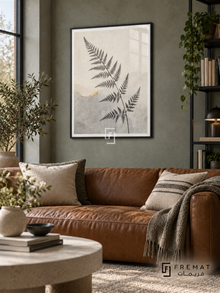 Fern Silhouette NAT16 by FREMAT in a slim matte black PVC frame, with an even white printed border, subtle glazing reflections and furniture showing scale.