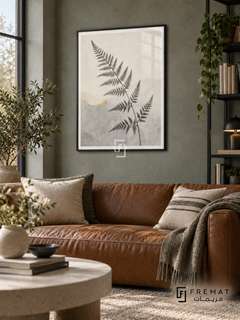 Fern Silhouette NAT16 by FREMAT in a slim matte black PVC frame, with an even white printed border, subtle glazing reflections and furniture showing scale.