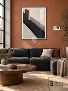 Shadow Stair (PLC02) framed architectural wall art with a matte black PVC frame, flat white paper border and glass reflection. Urban loft lounge, terracotta limewash wall, charcoal modular sofa 180cm.