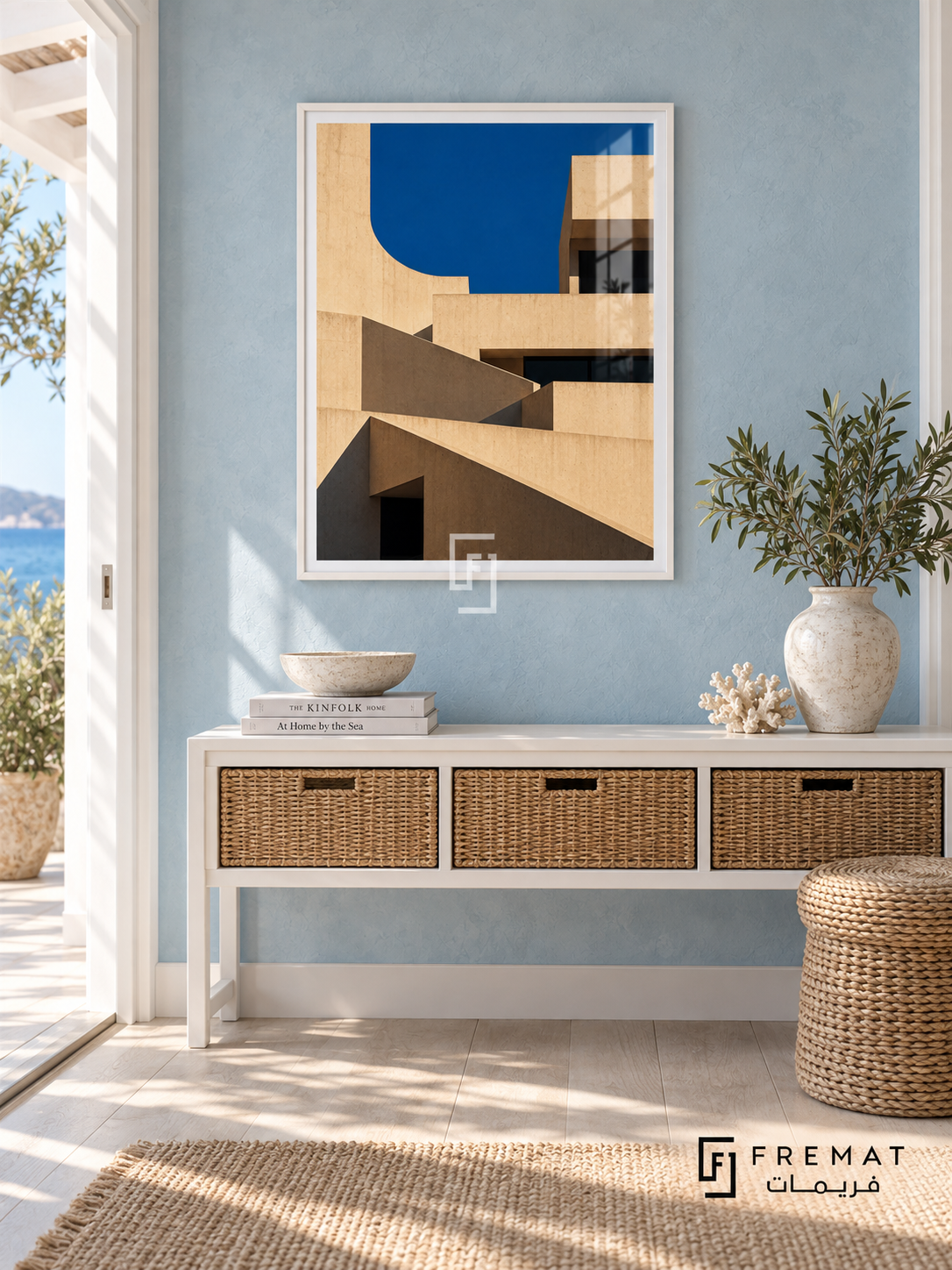 Terrace Forms (PLC09) framed architectural wall art with a satin white PVC frame, flat white paper border and glass reflection. Airy coastal hallway, pale blue limewash, white console 150cm with wicker drawers.