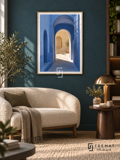 Passage Blue (PLC12) framed architectural wall art with a champagne gold PVC frame, flat white paper border and glass reflection. Contemporary reading lounge, deep teal textured wall, cream boucle settee 155cm.