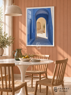 Passage Blue (PLC12) framed architectural wall art with a satin white PVC frame, flat white paper border and glass reflection. Fresh dining alcove, pale coral vertical timber wall, white tulip table 140cm.