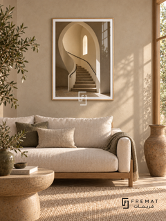 Stone Stairwell (PLC14) framed architectural wall art with a light wood-grain PVC frame, flat white paper border and glass reflection. Earthy sitting room, oatmeal plaster, low oak sofa 175cm with cream cushions.
