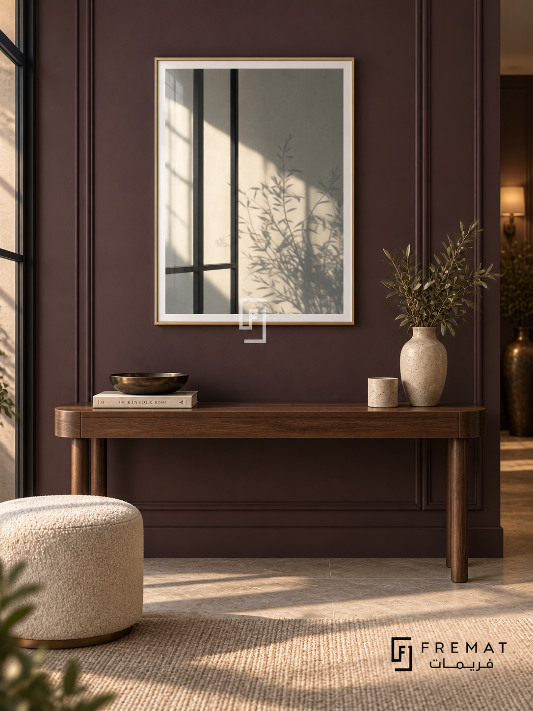 Window Shadows (PLC15) framed architectural wall art with a champagne gold PVC frame, flat white paper border and glass reflection. Quiet hotel-style foyer, deep aubergine paneled wall, slender walnut console 155cm.