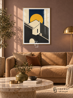 Roofline Sun (PLC16) framed architectural wall art with a champagne gold PVC frame, flat white paper border and glass reflection. Soft luxury lounge, smoky mauve suede wall, camel sofa 175cm.
