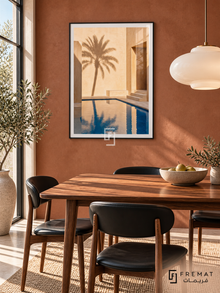 Courtyard Palm (PLC17) framed architectural wall art with a matte black PVC frame, flat white paper border and glass reflection. Midcentury dining corner, muted terracotta brick wall, walnut table 160cm.