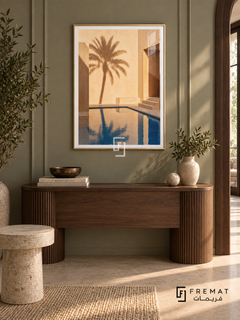 Courtyard Palm (PLC17) framed architectural wall art with a champagne gold PVC frame, flat white paper border and glass reflection. Elegant entrance gallery, olive-gray paneled wall, curved walnut console 150cm.