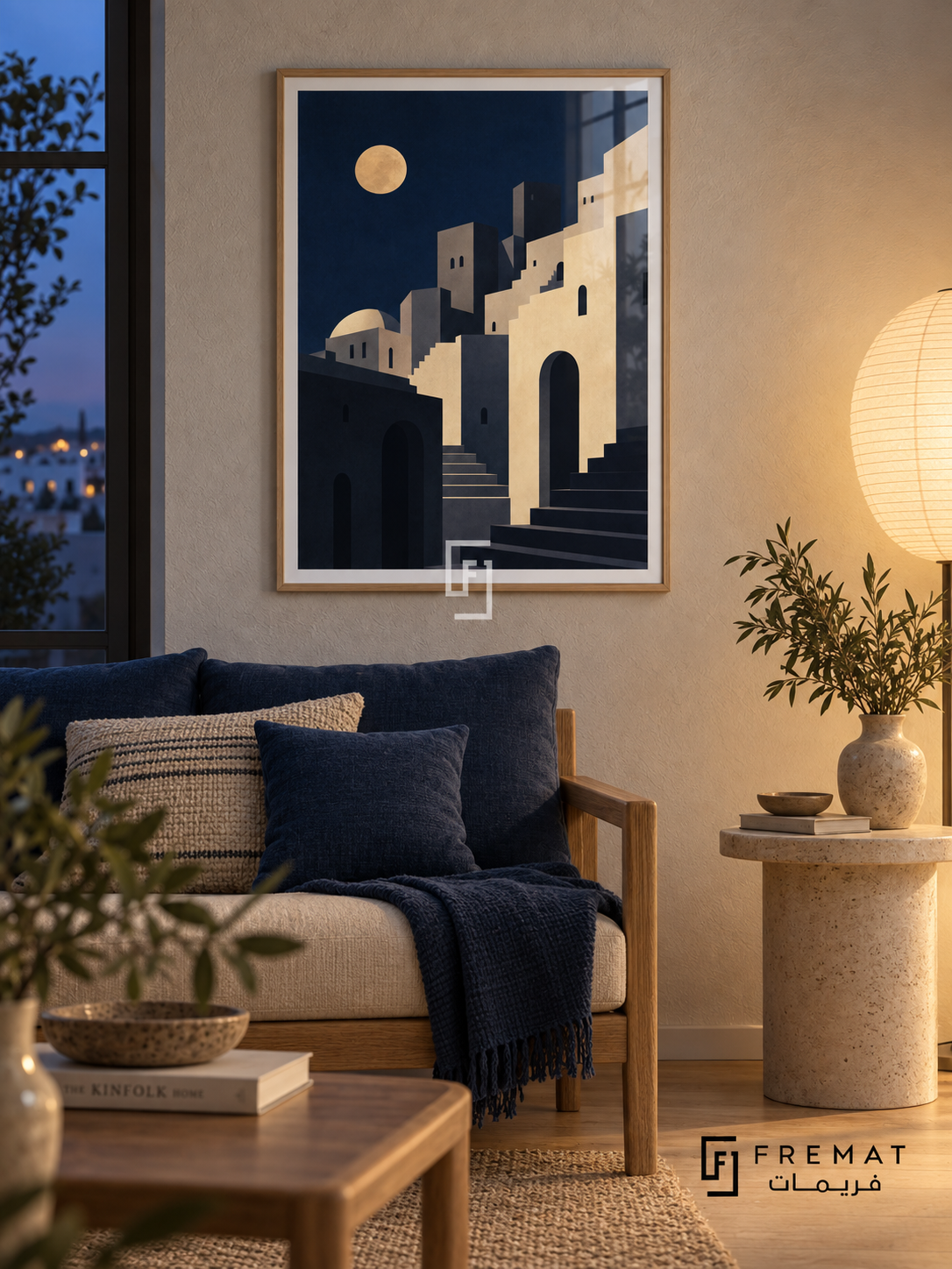 City Moon (PLC19) framed architectural wall art with a light wood-grain PVC frame, flat white paper border and glass reflection. Cozy evening lounge, off-white wool-texture wall, oak settee 165cm with deep blue cushions.