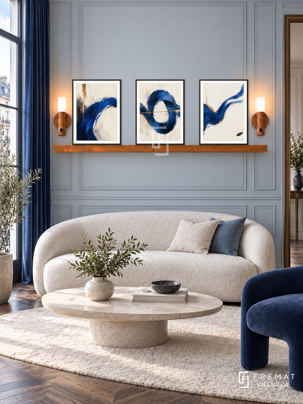 Cobalt Current shelf set, black frames: three 30 x 40 cm artworks with equal 2 cm borders, honey wood 130 cm shelf and two upward warm sensor lamps. Parisian salon in soft morning daylight.