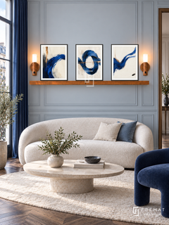 Cobalt Current shelf set, black frames: three 30 x 40 cm artworks with equal 2 cm borders, honey wood 130 cm shelf and two upward warm sensor lamps. Parisian salon in soft morning daylight.