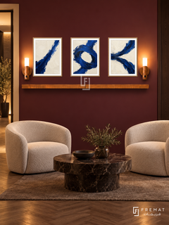 Ultramarine Tension complete shelf set in wooden texture frames: three 30 x 40 cm artworks with equal 2 cm borders, honey wood shelf and two sensor lamps. Burgundy reception at night.