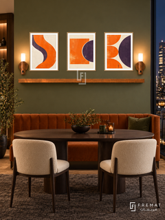 FREMAT SH-ABS28-WOD shelf set, three 30 x 40 cm artworks with 2 cm white mats, honey wood shelf and two upward sensor lamps. Night olive modern dining corner, green wall, orange velvet banquette, dark oak oval table, cream chairs, charcoal rug, skyline right.