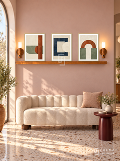 FREMAT SH-ABS30-GLD shelf set, three 30 x 40 cm artworks with 2 cm white mats, honey wood shelf and two upward sensor lamps. Morning peach reception, muted pink wall, cream scalloped bench, burgundy round side table, terrazzo floor, arched window left.