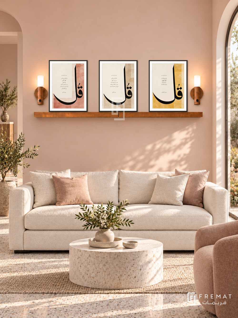 FREMAT Three Quls shelf set with three 30 x 40 cm frames, 2 cm white borders, honey wood shelf and two warm sensor lamps. Morning serene pale peach reception, blush wall, ivory sofa, white stone cylindrical table, light terrazzo floor, arched garden window right.