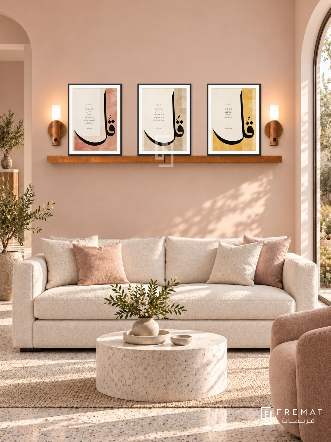 FREMAT Three Quls shelf set with three 30 x 40 cm frames, 2 cm white borders, honey wood shelf and two warm sensor lamps. Morning serene pale peach reception, blush wall, ivory sofa, white stone cylindrical table, light terrazzo floor, arched garden window right.